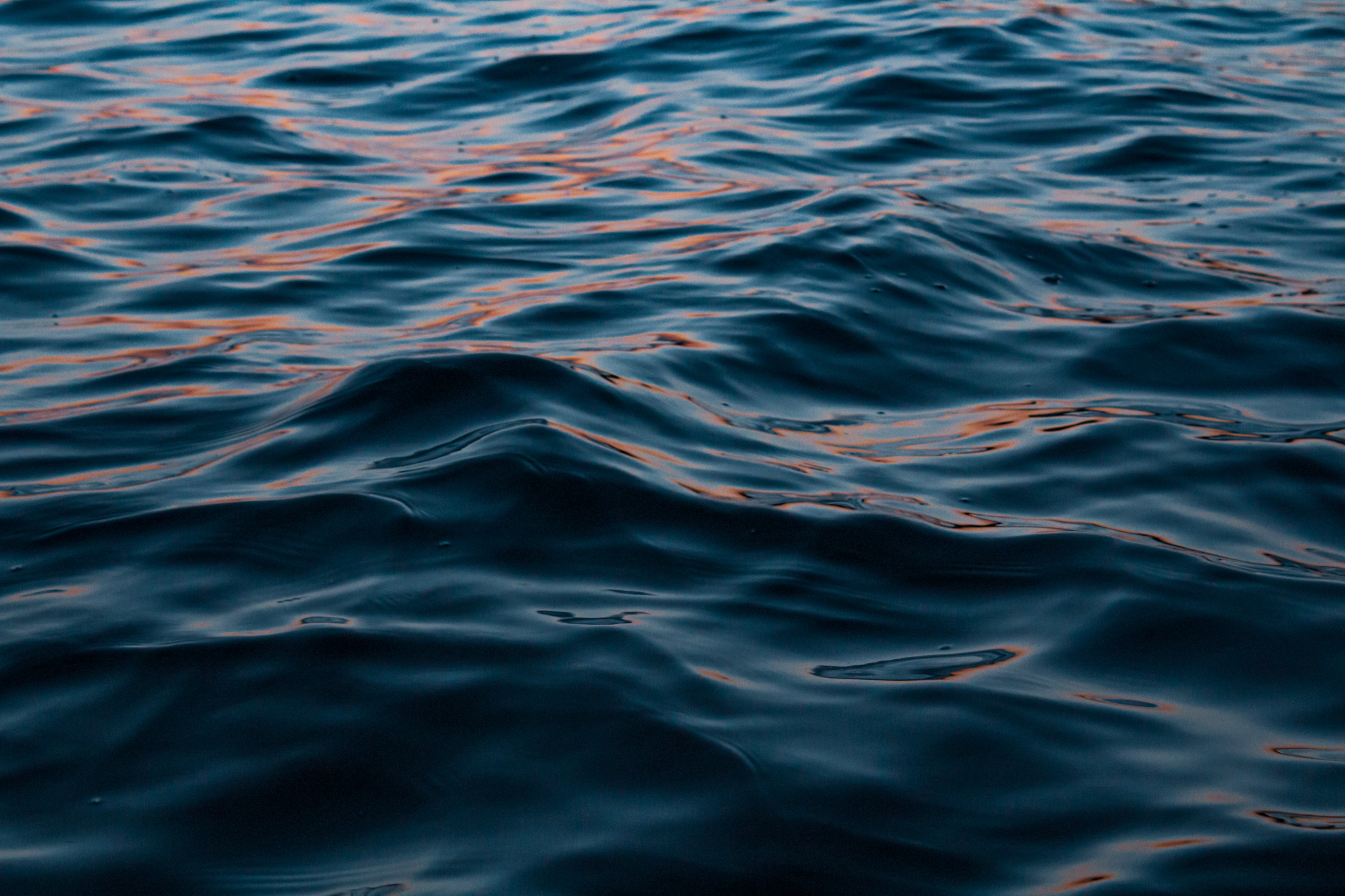 Ripples in a Michigan Lake hold sunset light